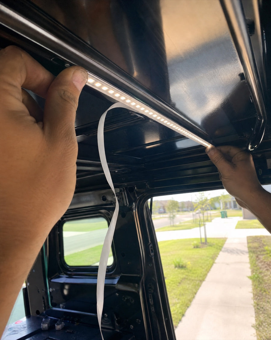 Pressing the LED bar into the ceiling channel of a truck cap