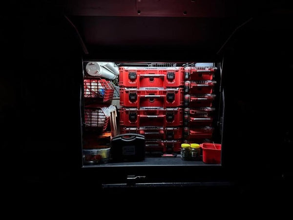 Stack of tool cases lit inside a truck box